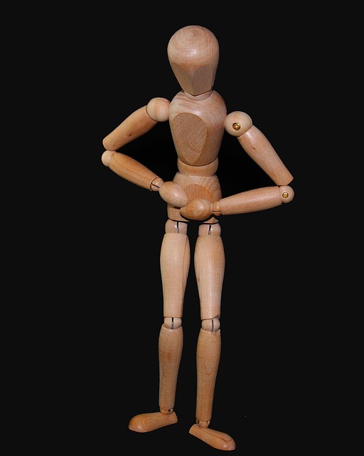 Figurine en bois se tenant le ventre en signe de douleur abdominale