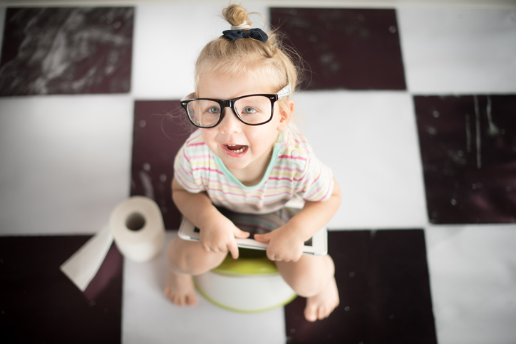 un petit enfant portant des lunettes de soleil assis sur le pot