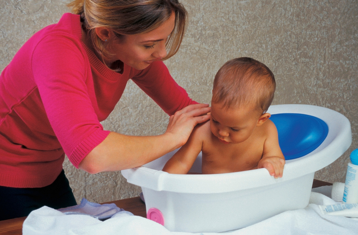 Mère baignant son bébé dans la baignoire